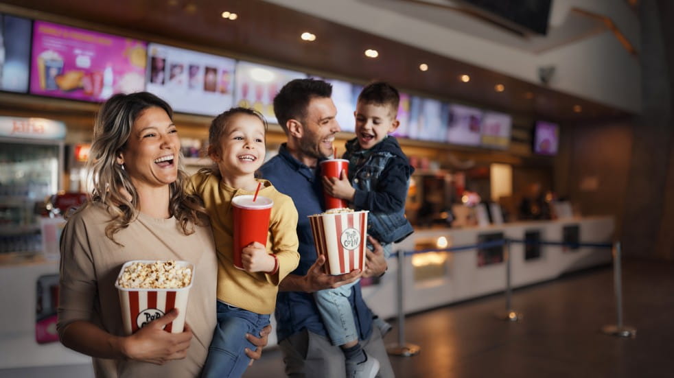 Family in cinema foyer with popcorn